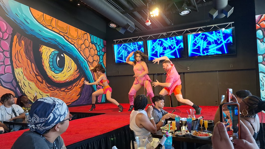 Three drag queens performing live on stage at Viva Drag Brunch.