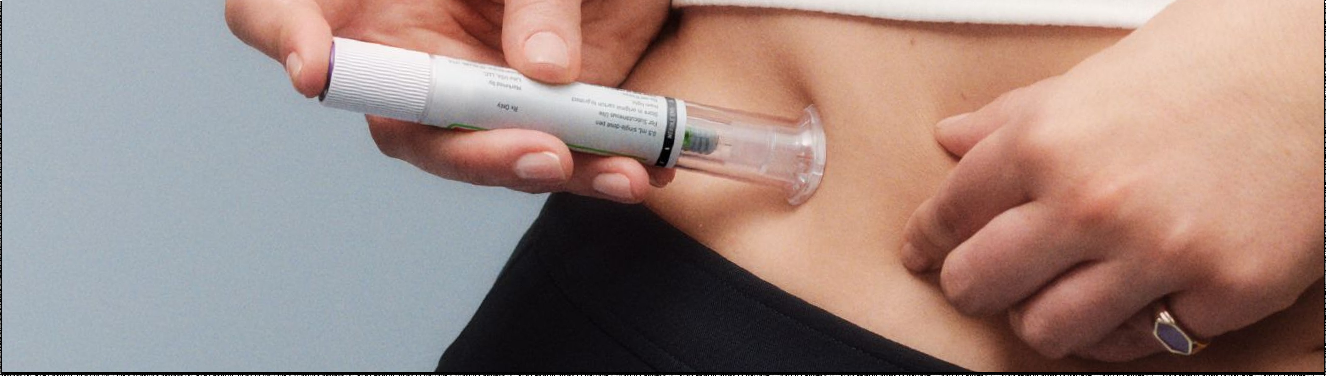Person using a GLP-1 injection pen