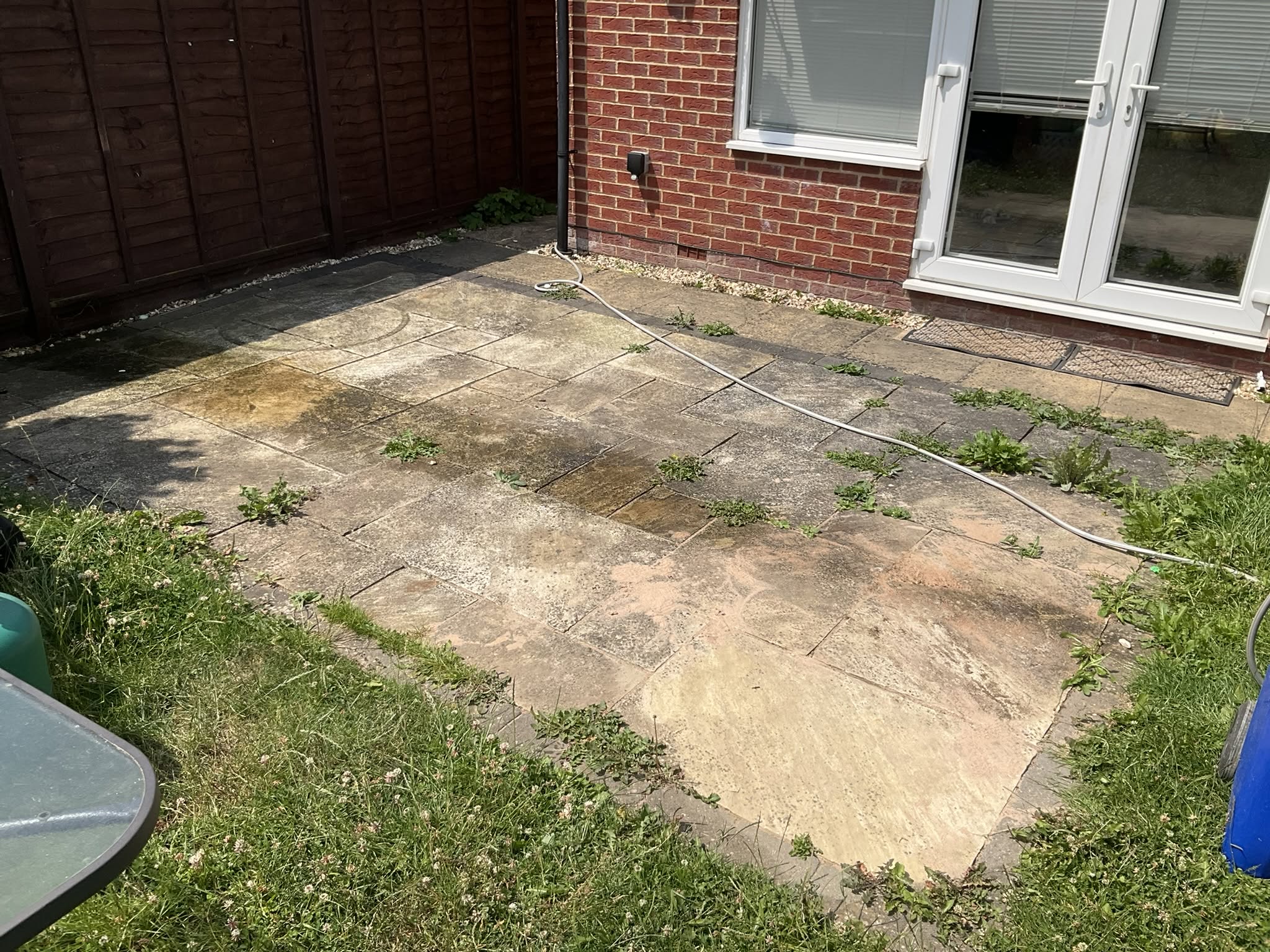 Stone patio in Gloucester before professional deep cleaning by Glevum Hydro