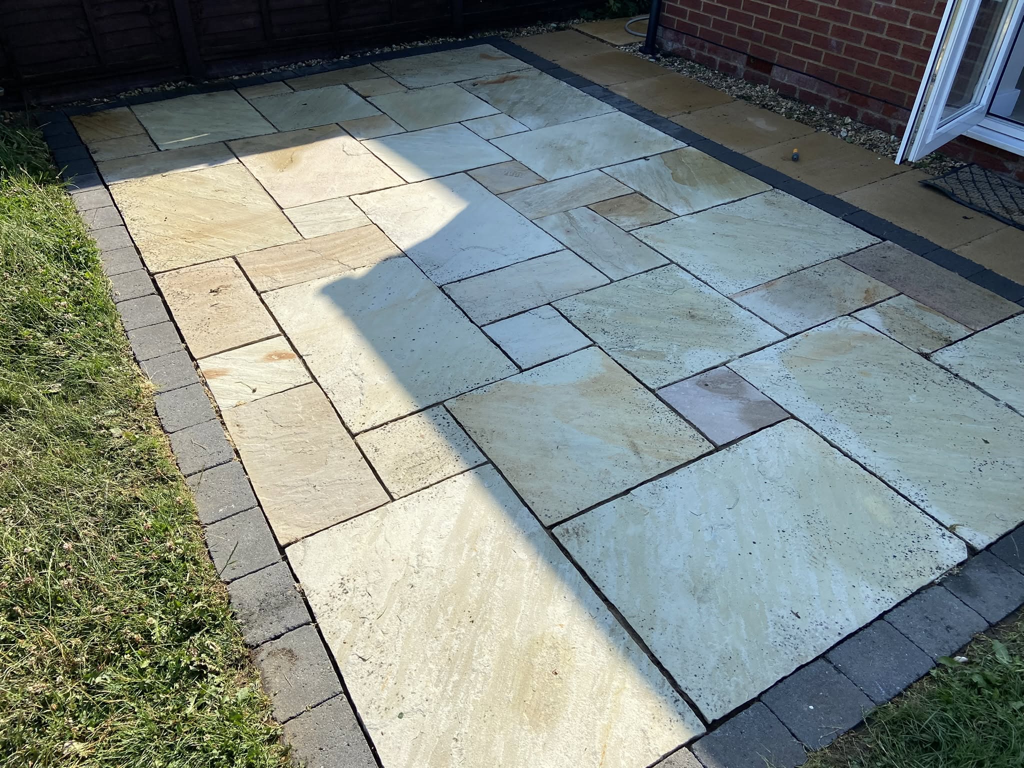 Stone patio in Gloucester after professional deep cleaning restoring natural colour by Glevum Hydro