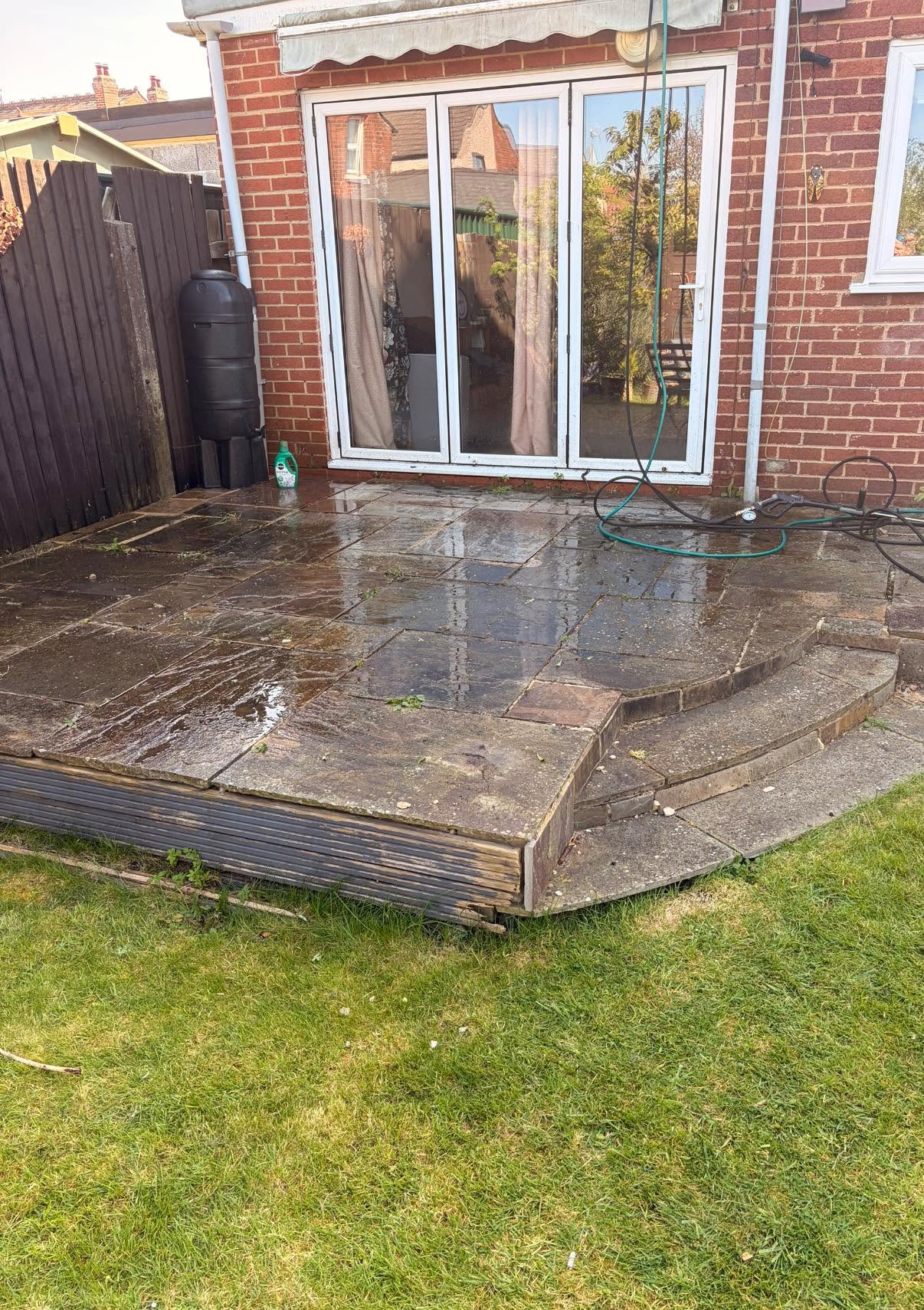 Natural stone patio in Gloucester with black spot and algae before treatment by Glevum Hydro