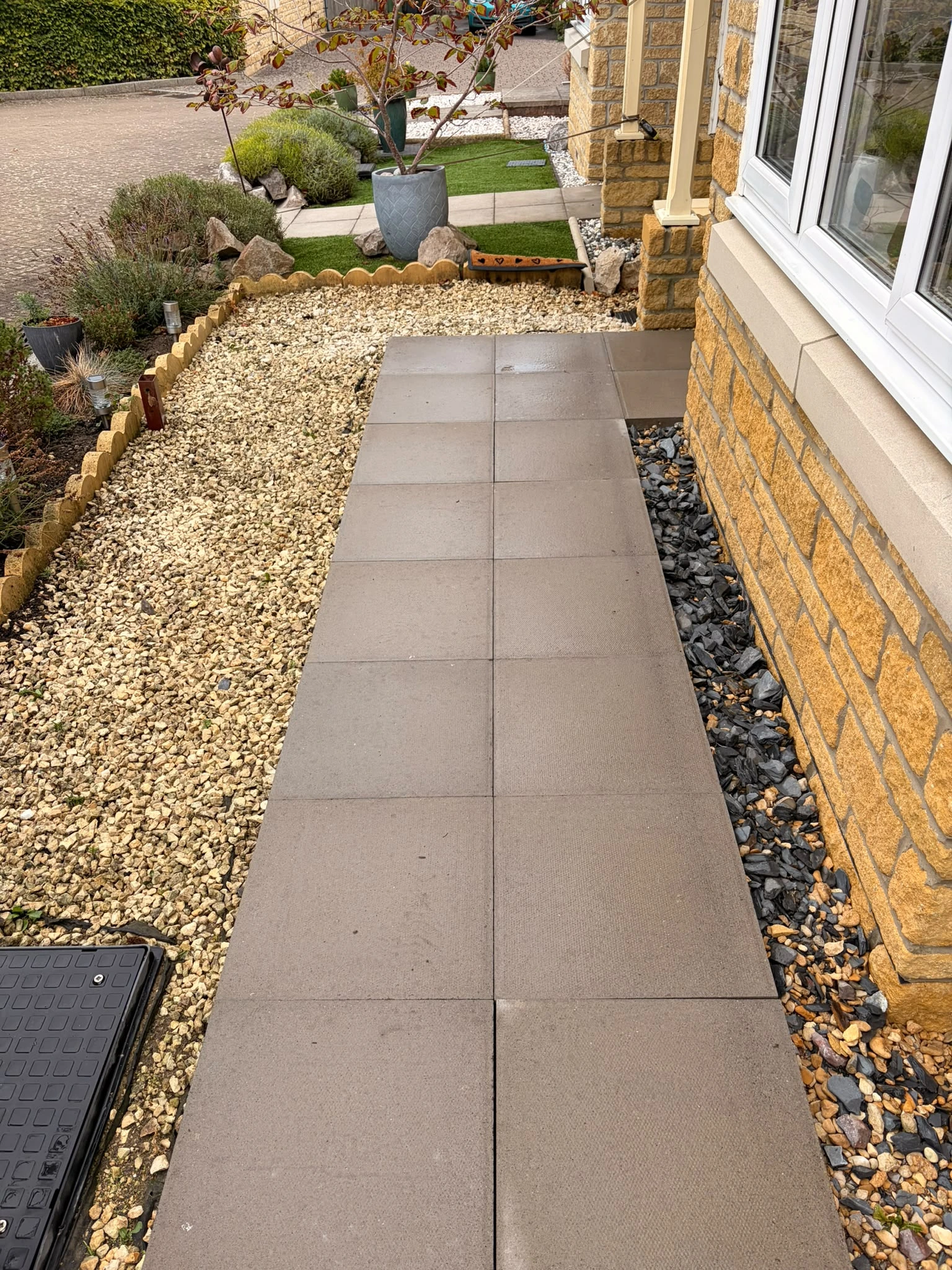 Outdoor patio in Gloucester covered in green algae and dirt before soft washing by Glevum Hydro