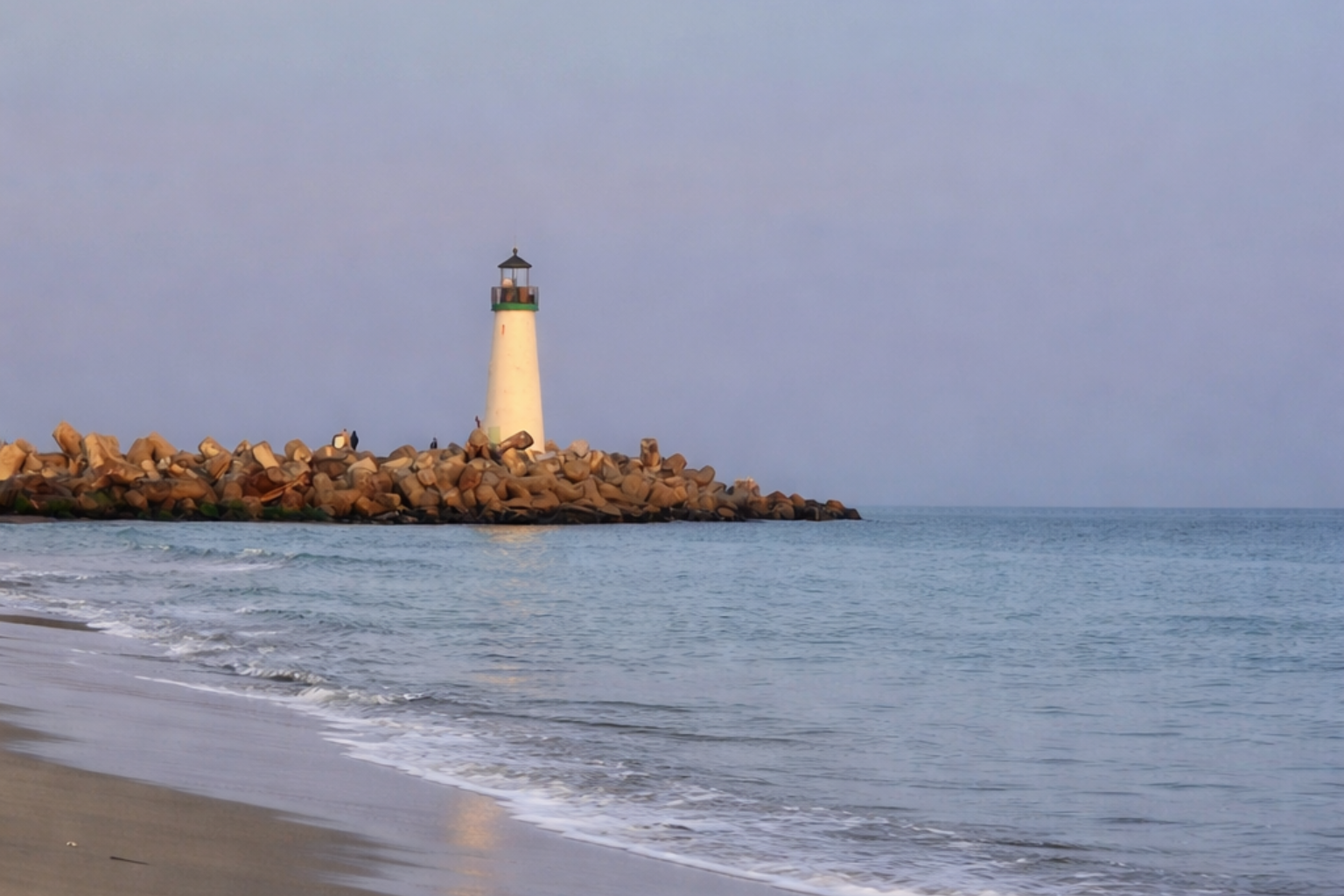 A lighthouse at the end of a breakwater