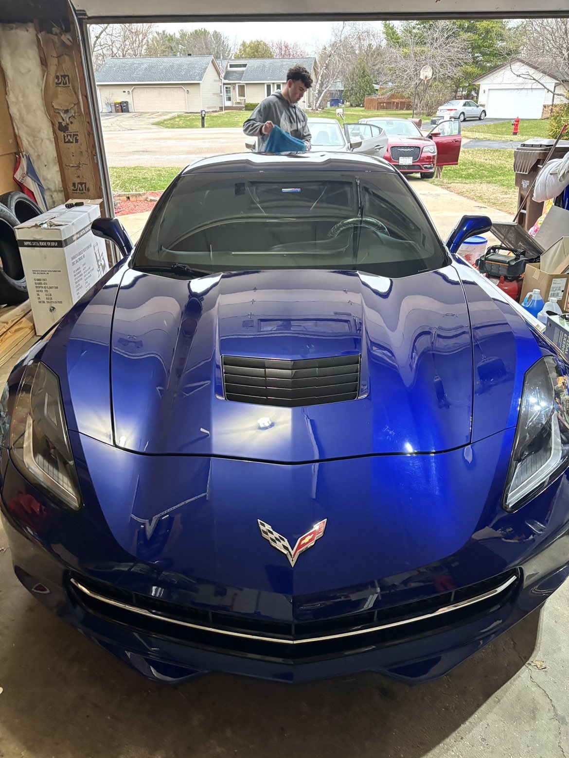 KJ detailing a blue Corvette
