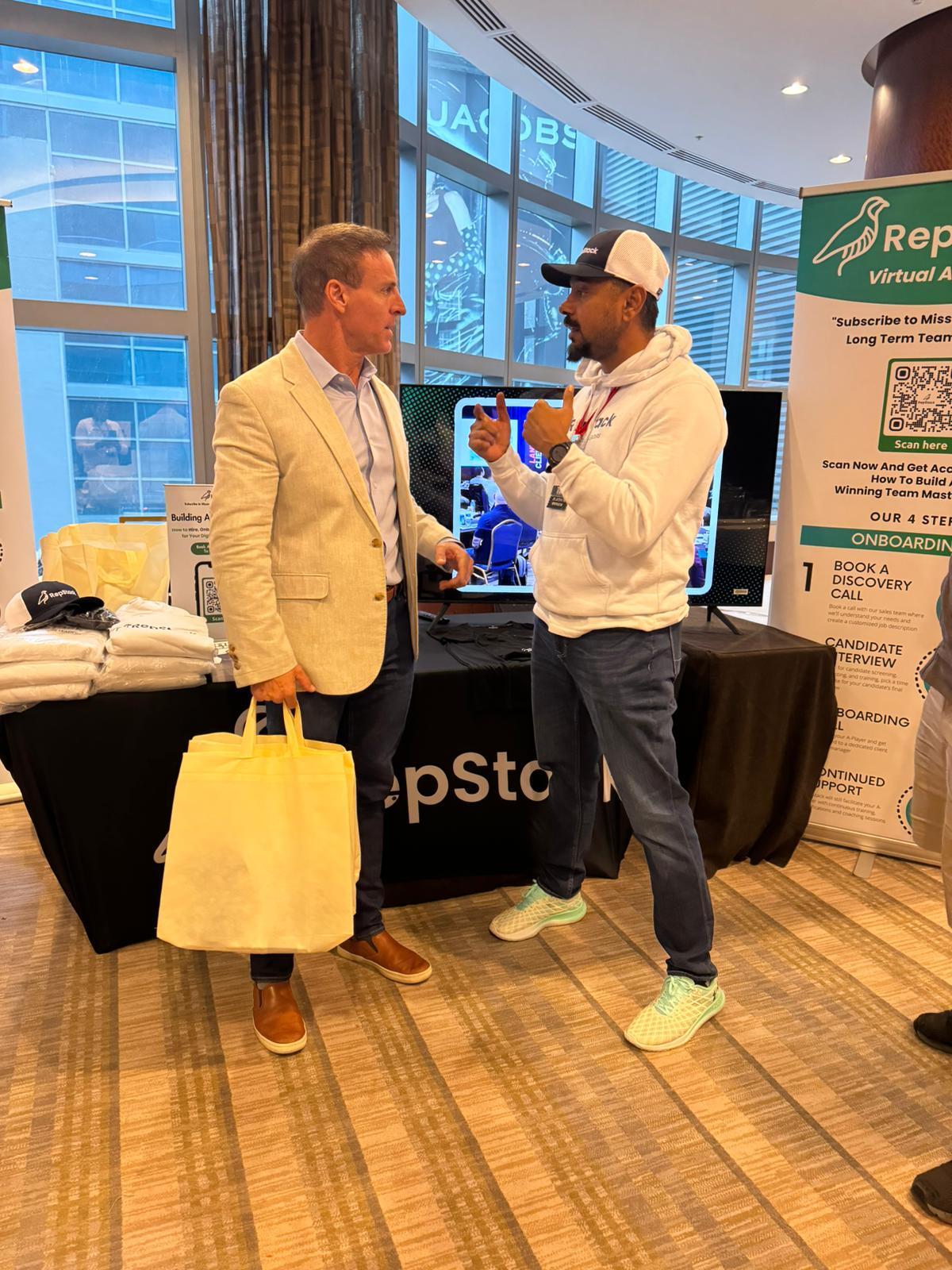 Andrew Cass talking with RepStack's CEO at the RepStack booth