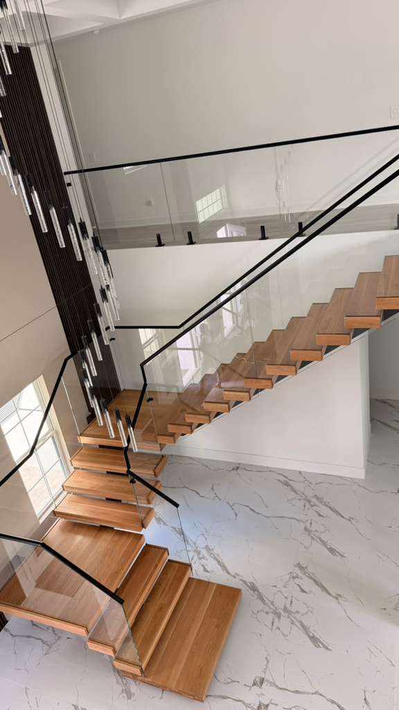 Custom floating staircase engineered, fabricated and installed in Florida by Railing Max