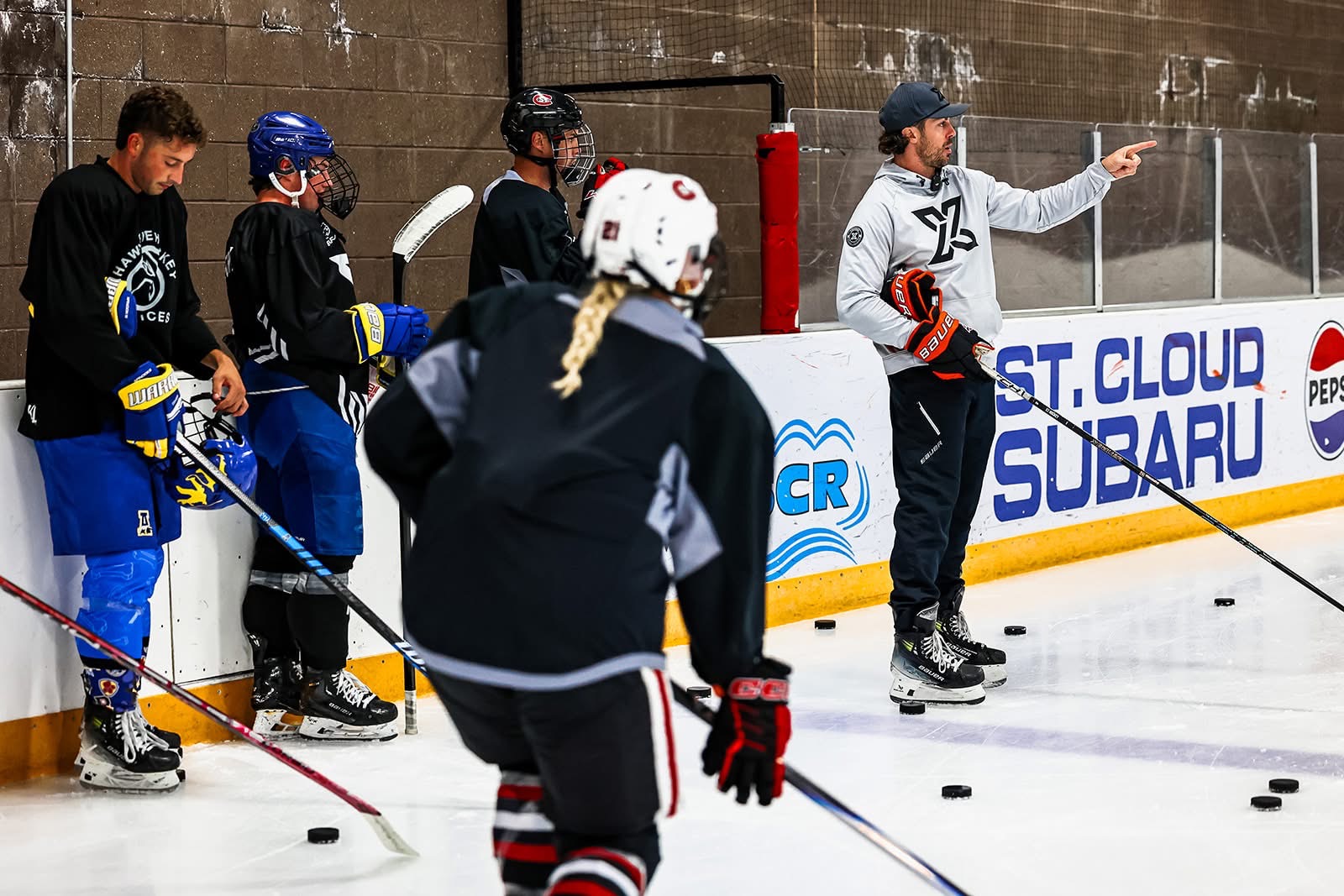 John Swanson coaching players on ice
