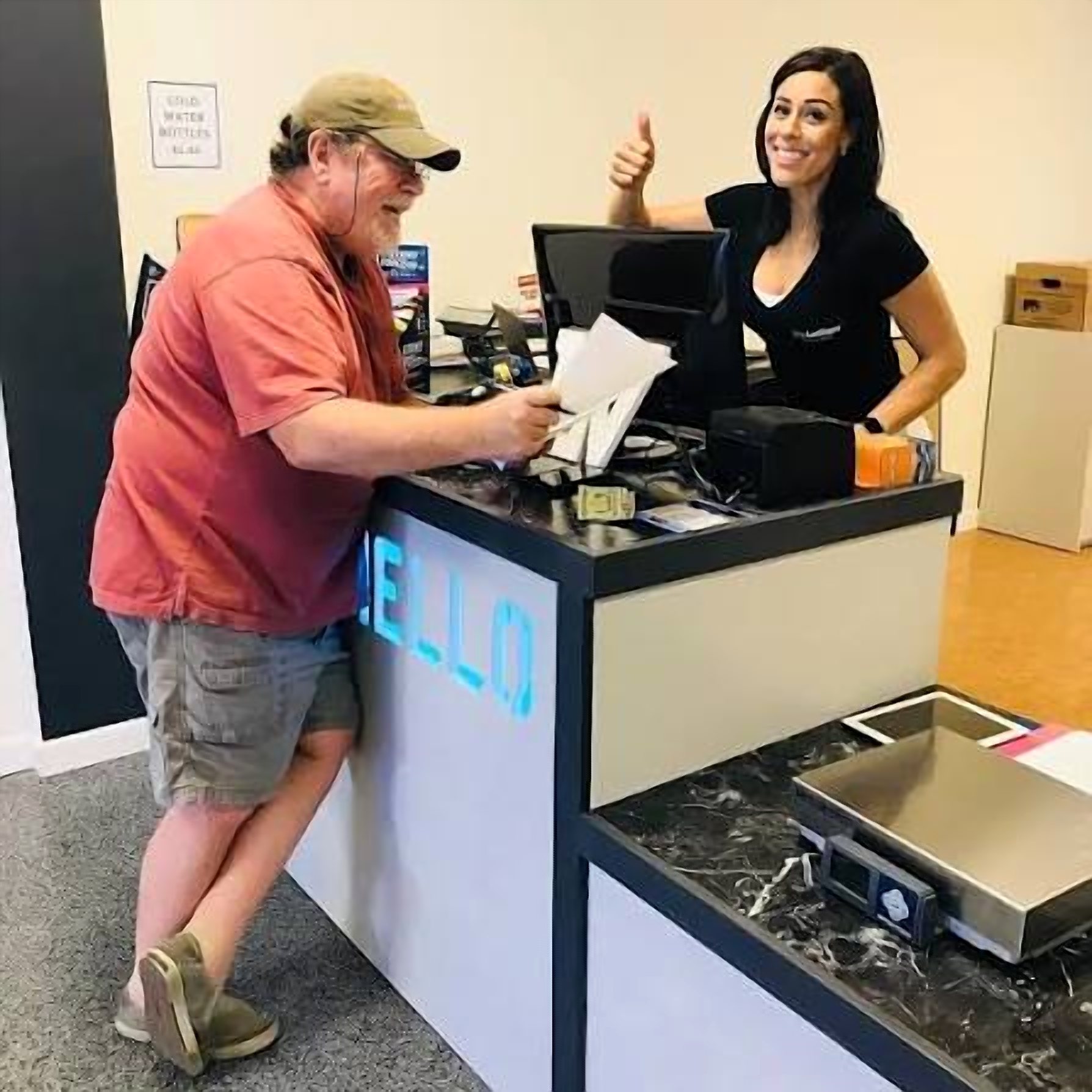 A customer at the Ship Las Vegas counter with a staff member giving a thumbs up