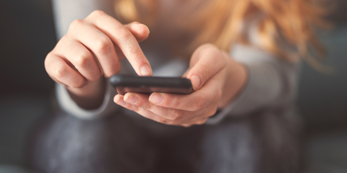 Hands scrolling through a phone instead of spending quality time together Hands scrolling through a phone instead of spending quality time together