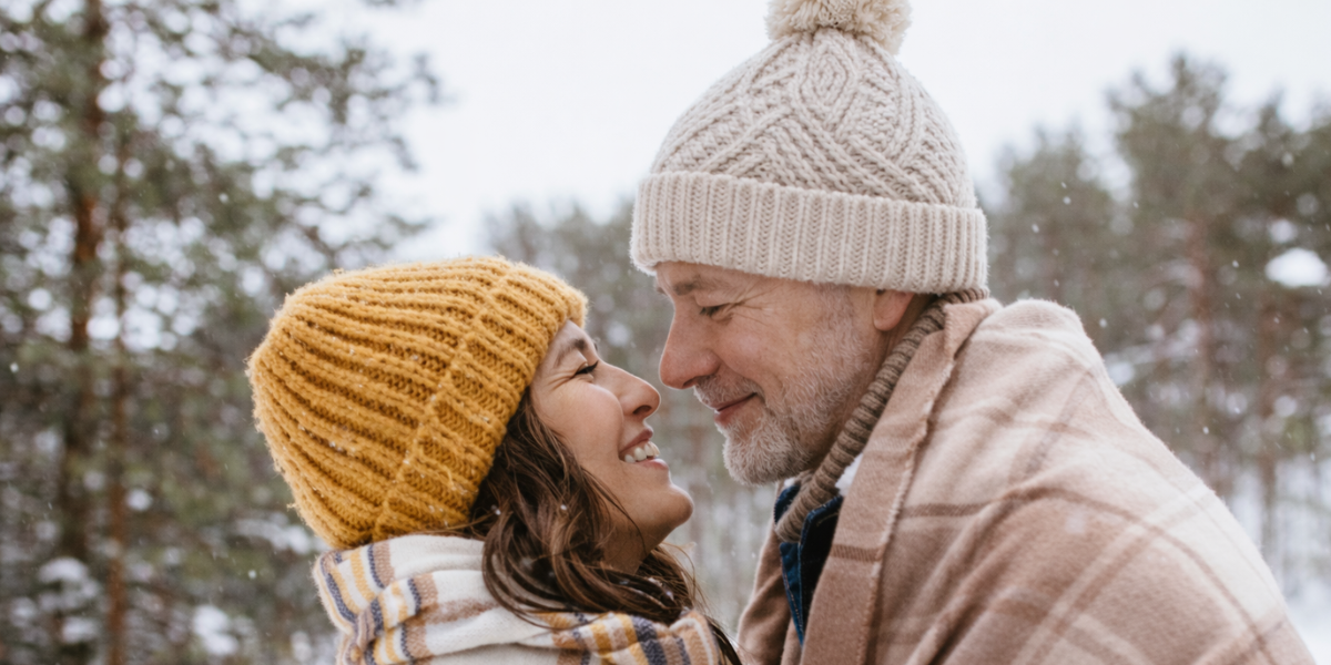 Man and woman over 50 smiling and leaning in close outdoors, showing warmth, connection and affection Man and woman over 50 smiling and leaning in close outdoors, showing warmth, connection and affection