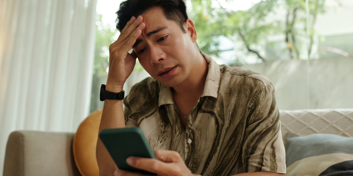 Man holding phone waiting after being ghosted