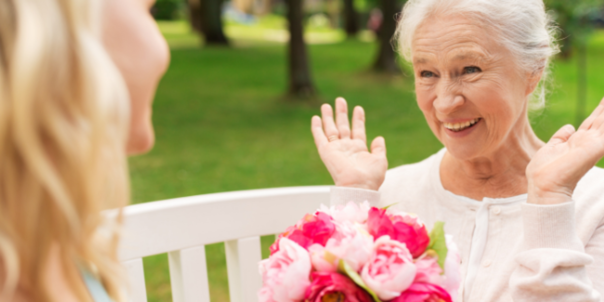 A woman giving another woman flowers showing her love by giving a gift A woman giving another woman flowers showing her love by giving a gift