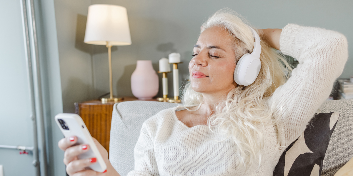 Crystal singing bowls outdoors on grass with coloured glow, used for relaxing sound bath sessions