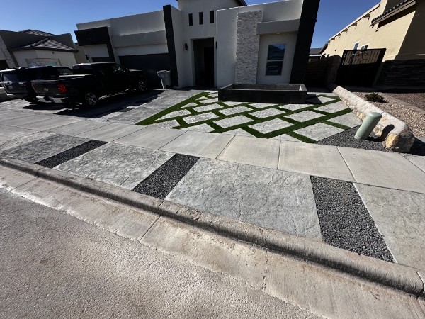 Completed residential yard with artificial turf and paver strips