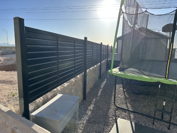 Black horizontal metal fence along backyard