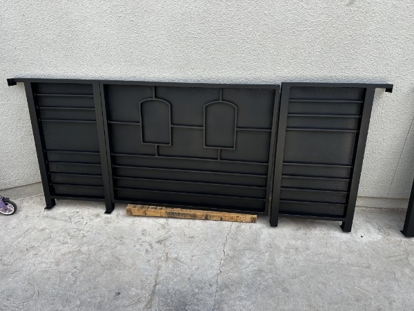Black metal equipment enclosure against wall