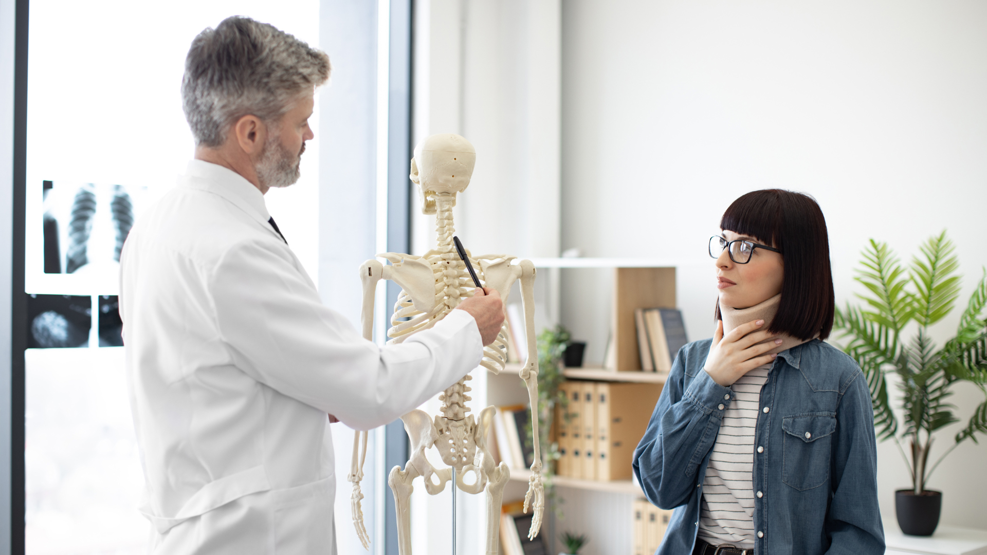 Chiropractor explaining care to a patient through video