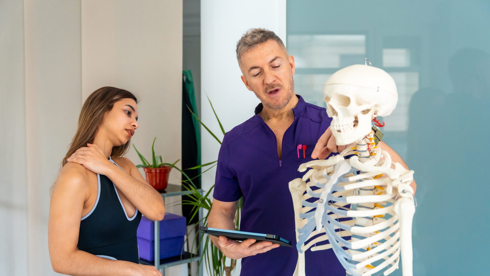 A chiropractor explaining health information to a patient