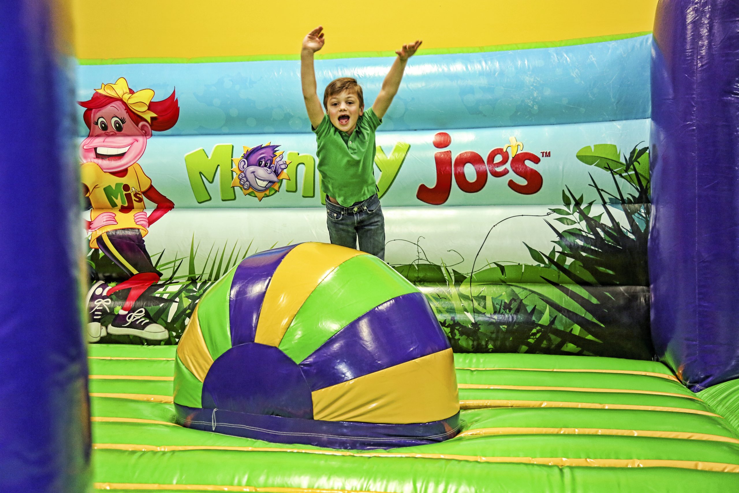 Kid jumping with excitement on inflatables