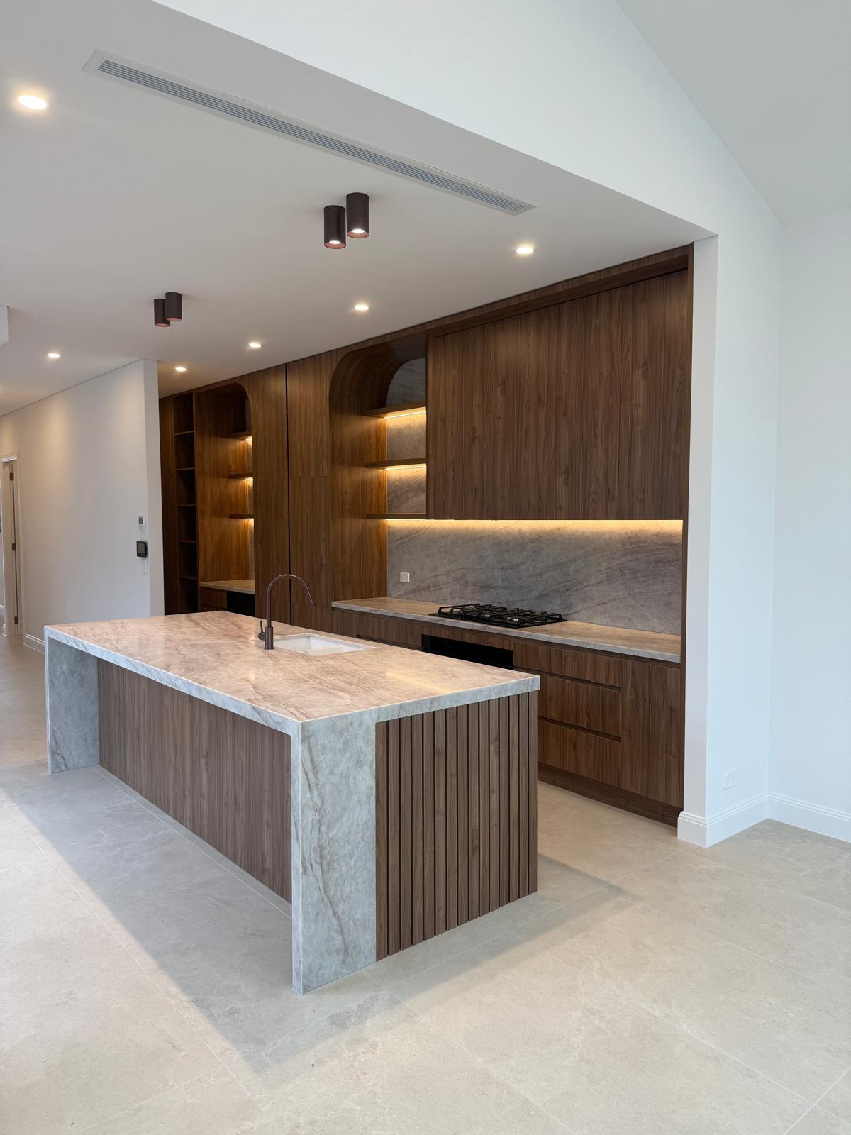 Hand crafted walnut kitchen with fluted stone island