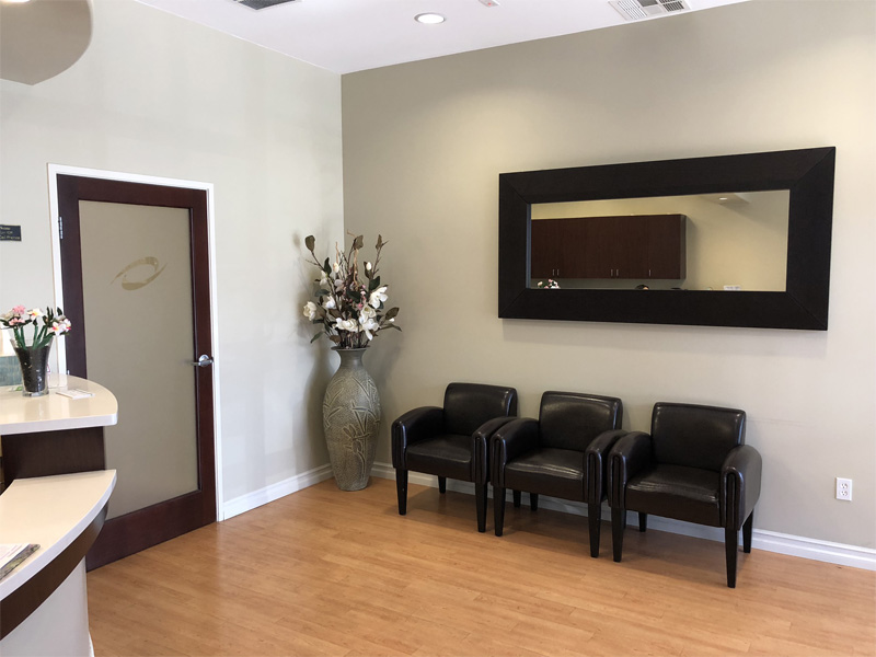 Waiting area with chairs and a wall mirror