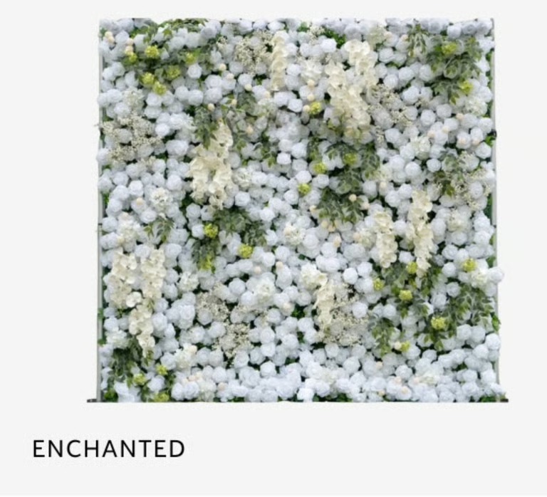 White flower wall with lush green foliage