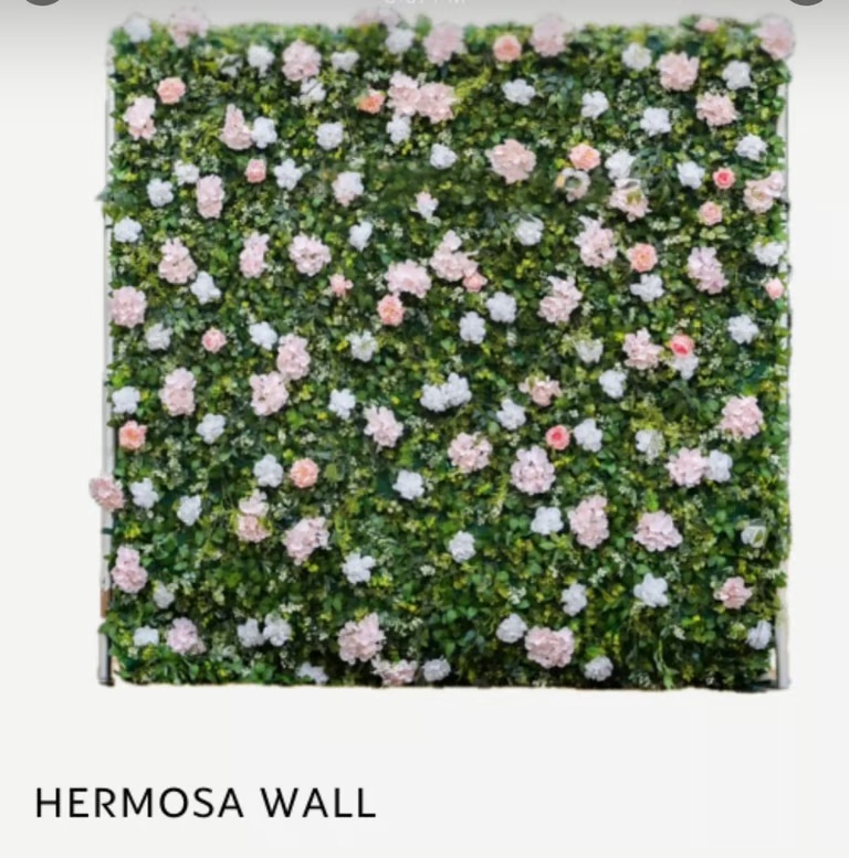 Green living wall with pink & white flowers