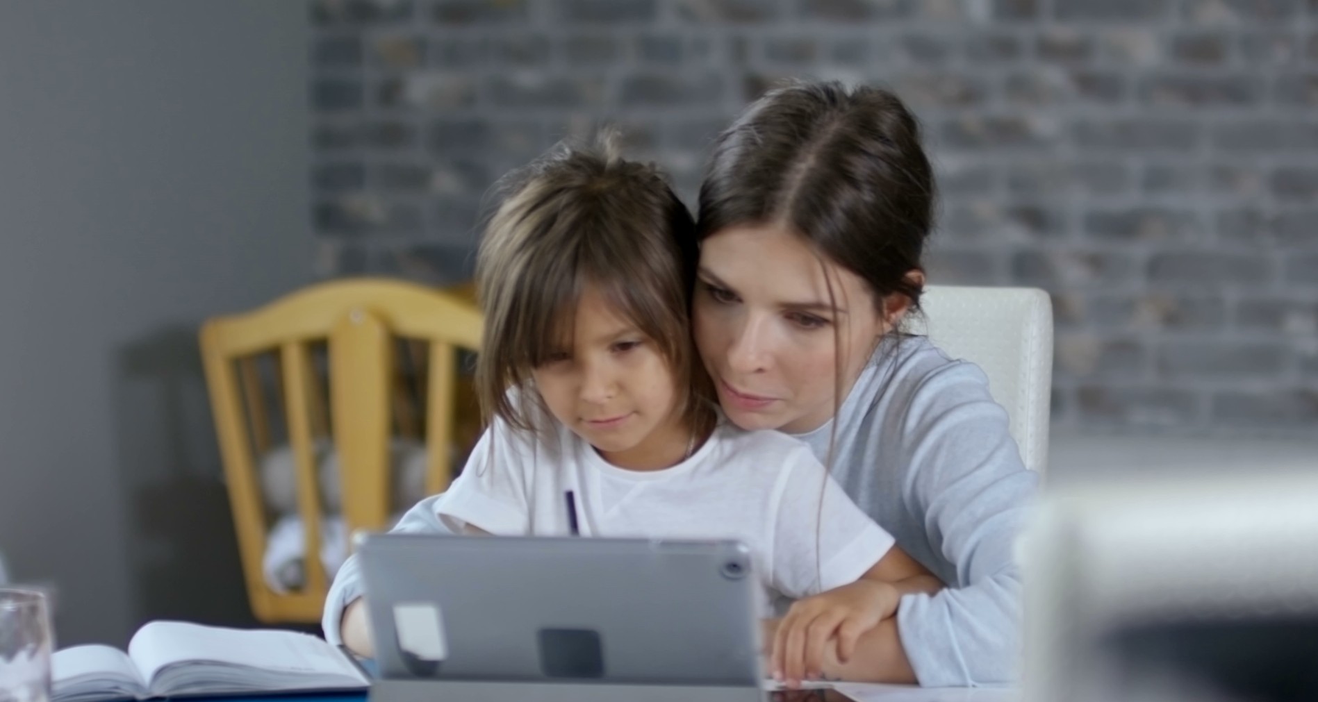 Mother and daughter working together at the kitchen table