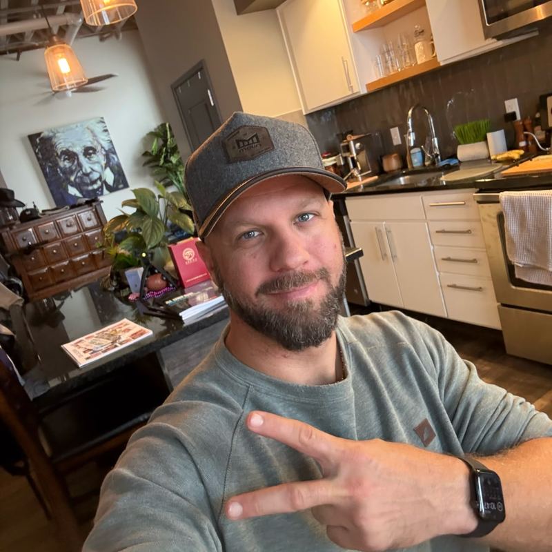 Me smiling with a peace sign at my office