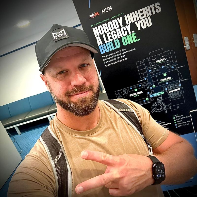 Me in front of a sign that reads Nobody inherits a legacy. You build one.