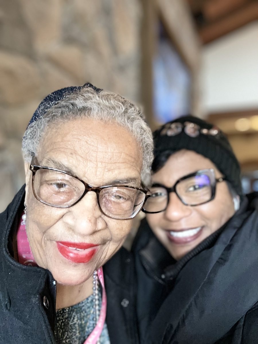 Anita Charlot and her mother, cheek to cheek and smiling