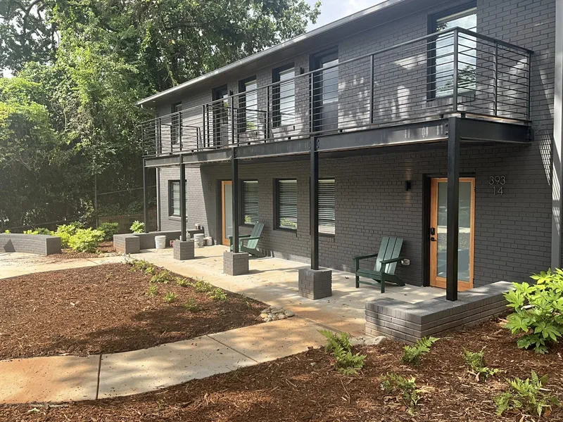 Steel balcony and post framing along an apartment courtyard