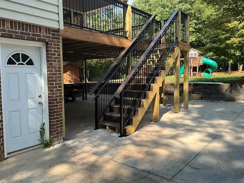 Black steel exterior staircase and deck railing on a two-storey home