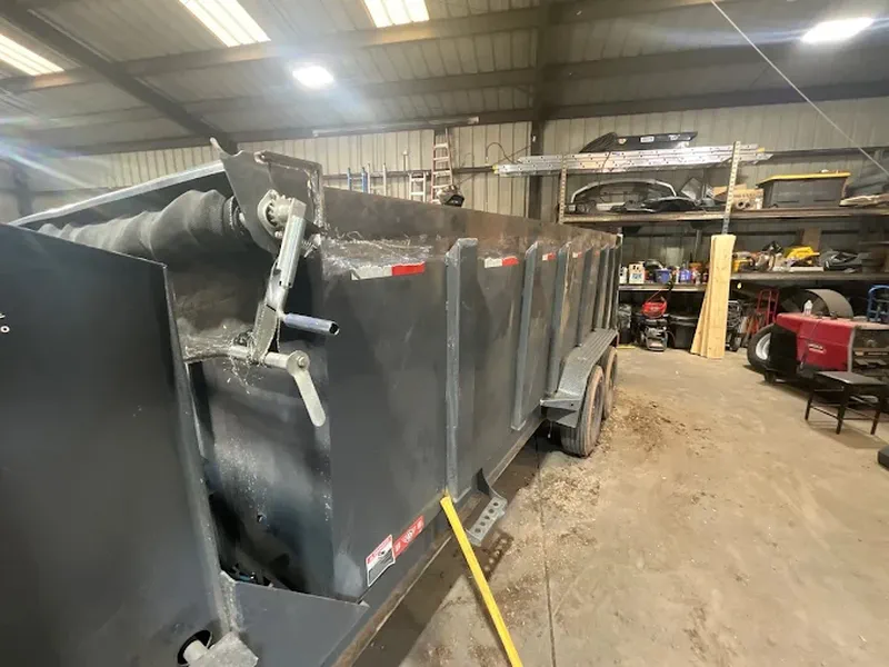 Dump body with hydraulic hoist mounted on a truck chassis