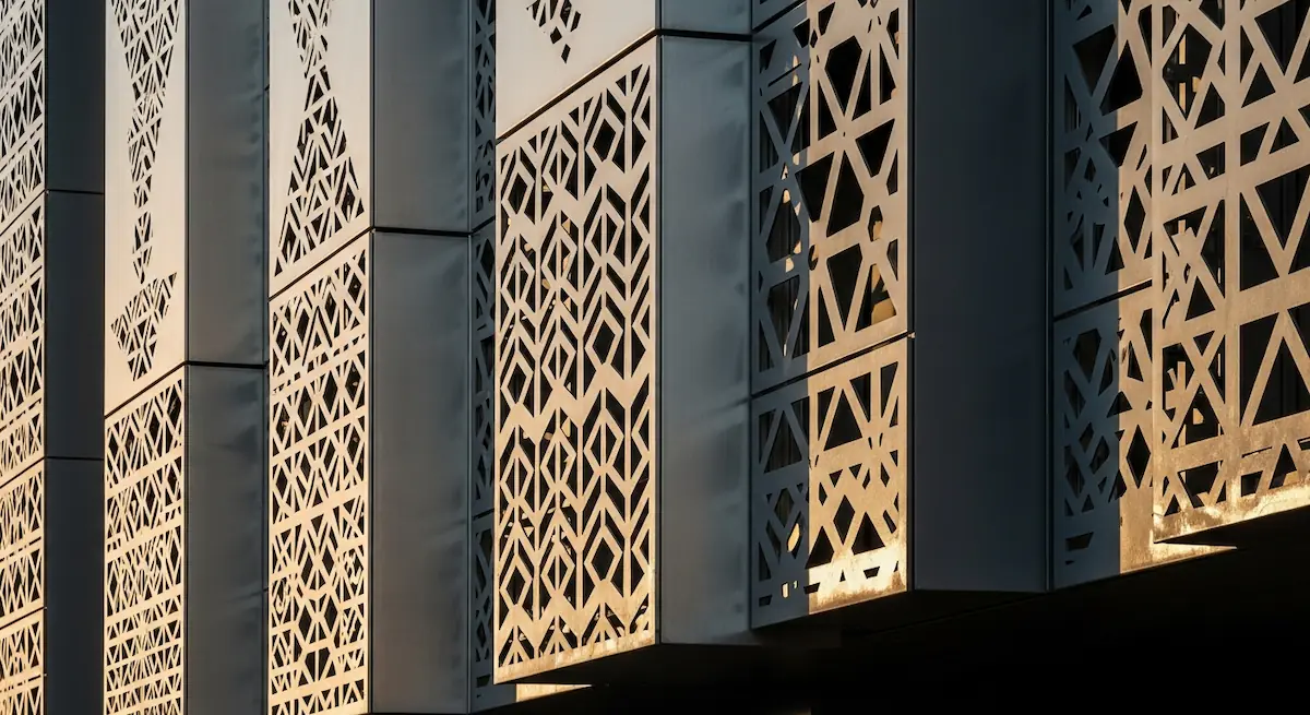 Perforated metal panels forming a patterned architectural facade screen
