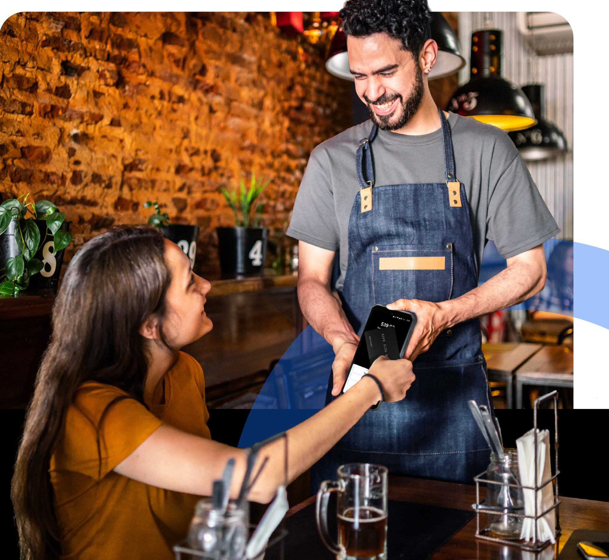Server taking a tap-to-pay payment on a SkyTab handheld at the table