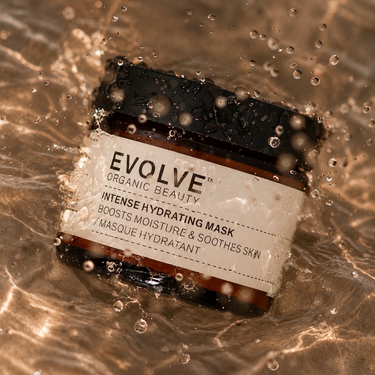 A jar of Evolve Intense Hydrating Mask in splashing water