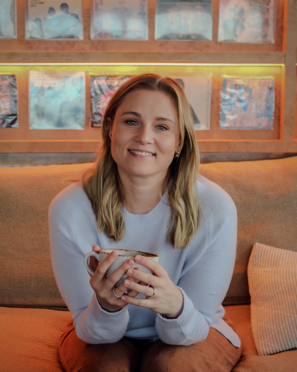 Danni, founder of Tide & Wild, holding a cup of tea