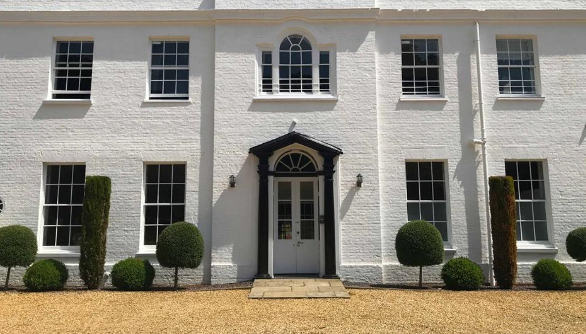 The white Georgian front entrance of The Retreat New Forest