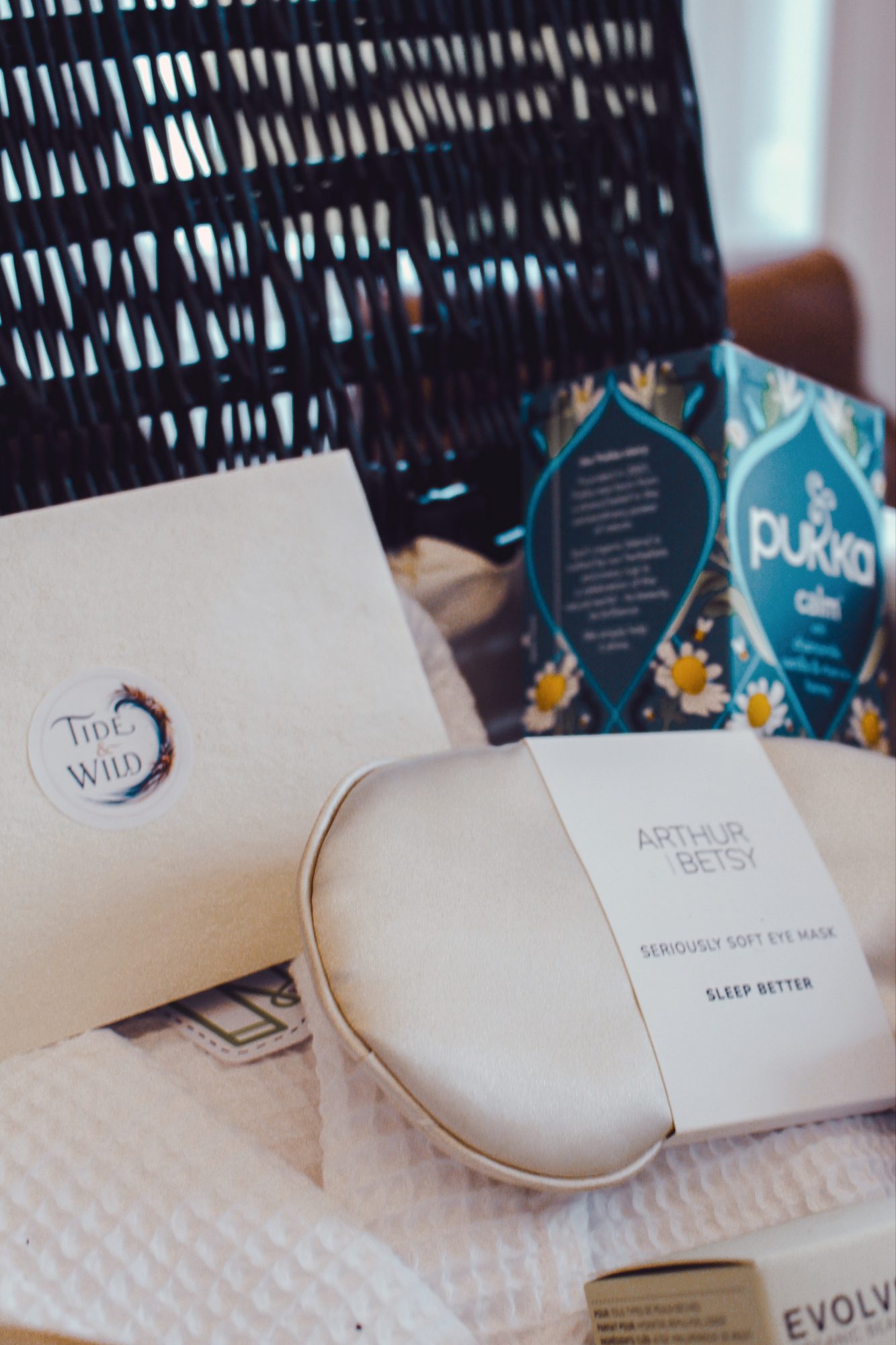 Close up of the Tide & Wild card, Arthur & Betsy eye mask, Pukka Calm tea and waffle robe