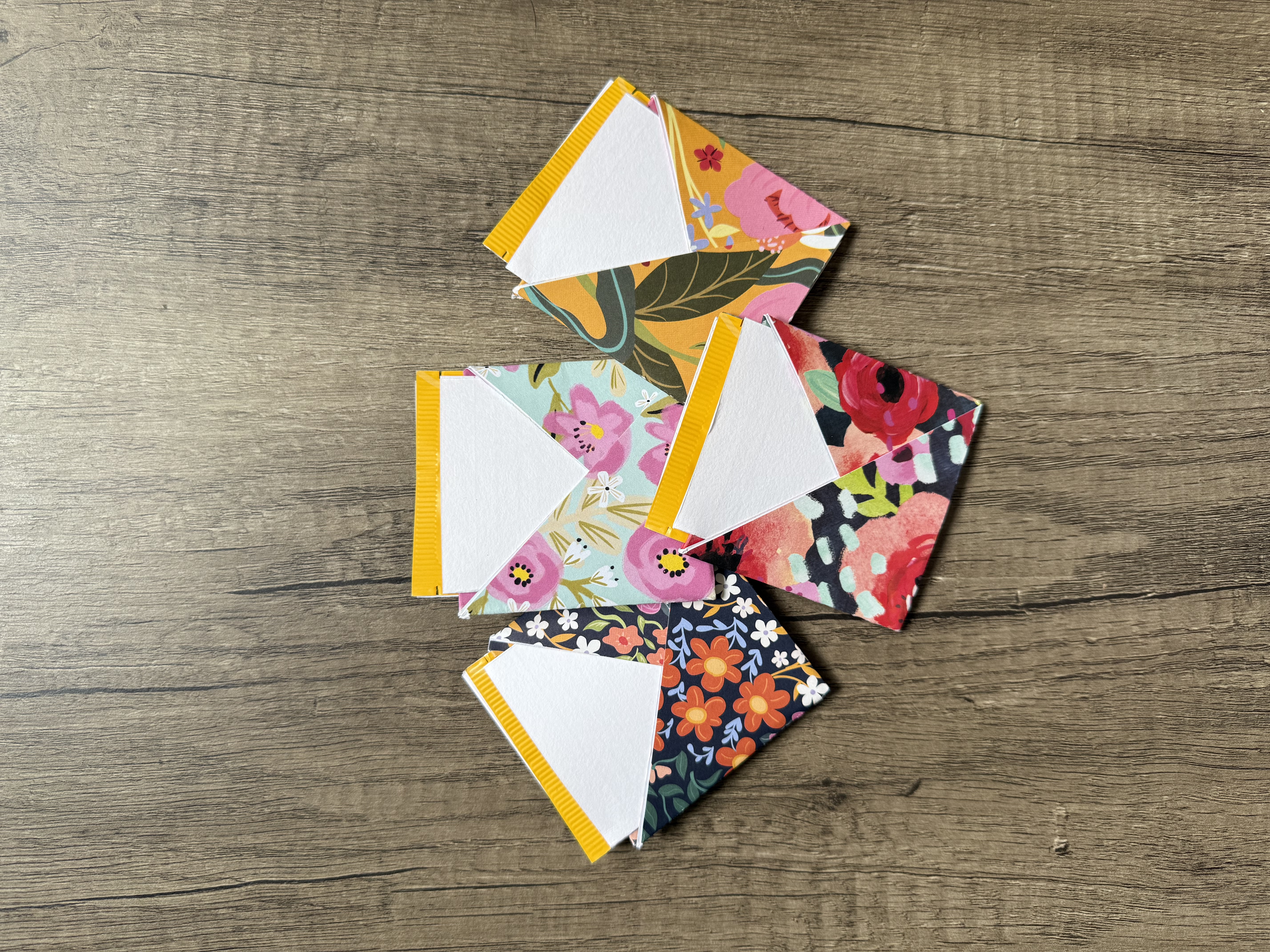 Four origami envelopes with a tea bag and affirmation card inside each