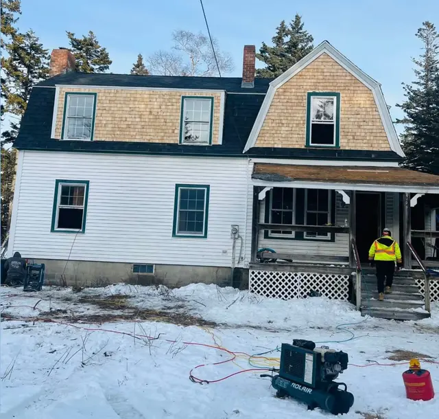 FJM Construction crew on a winter siding job with cedar shingle and clapboard siding on the North Shore