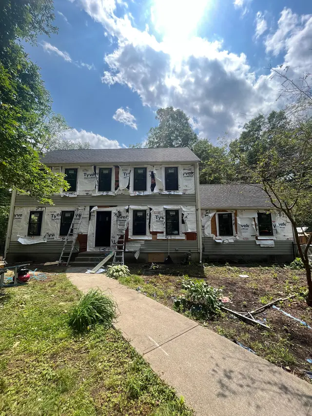 FJM Construction siding replacement with new house wrap on a colonial home on the North Shore