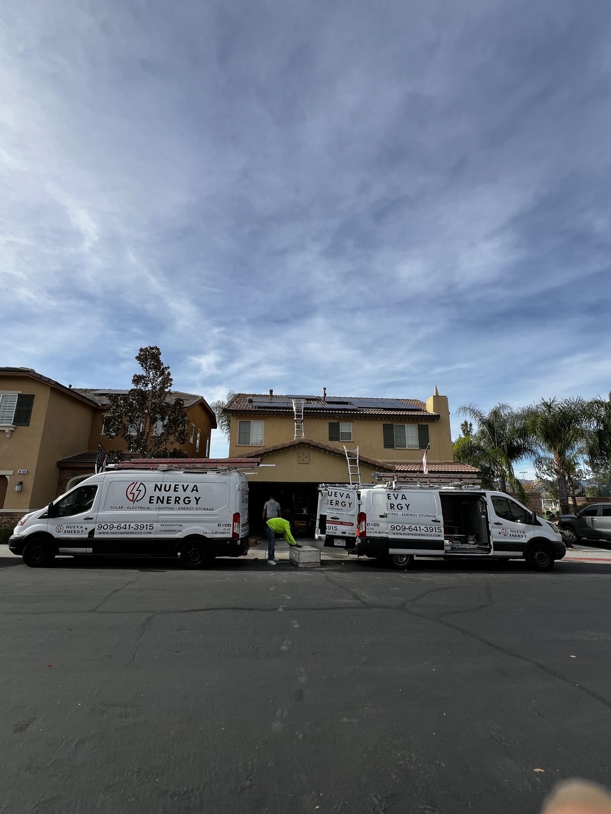Nueva Energy crew vans at a job site