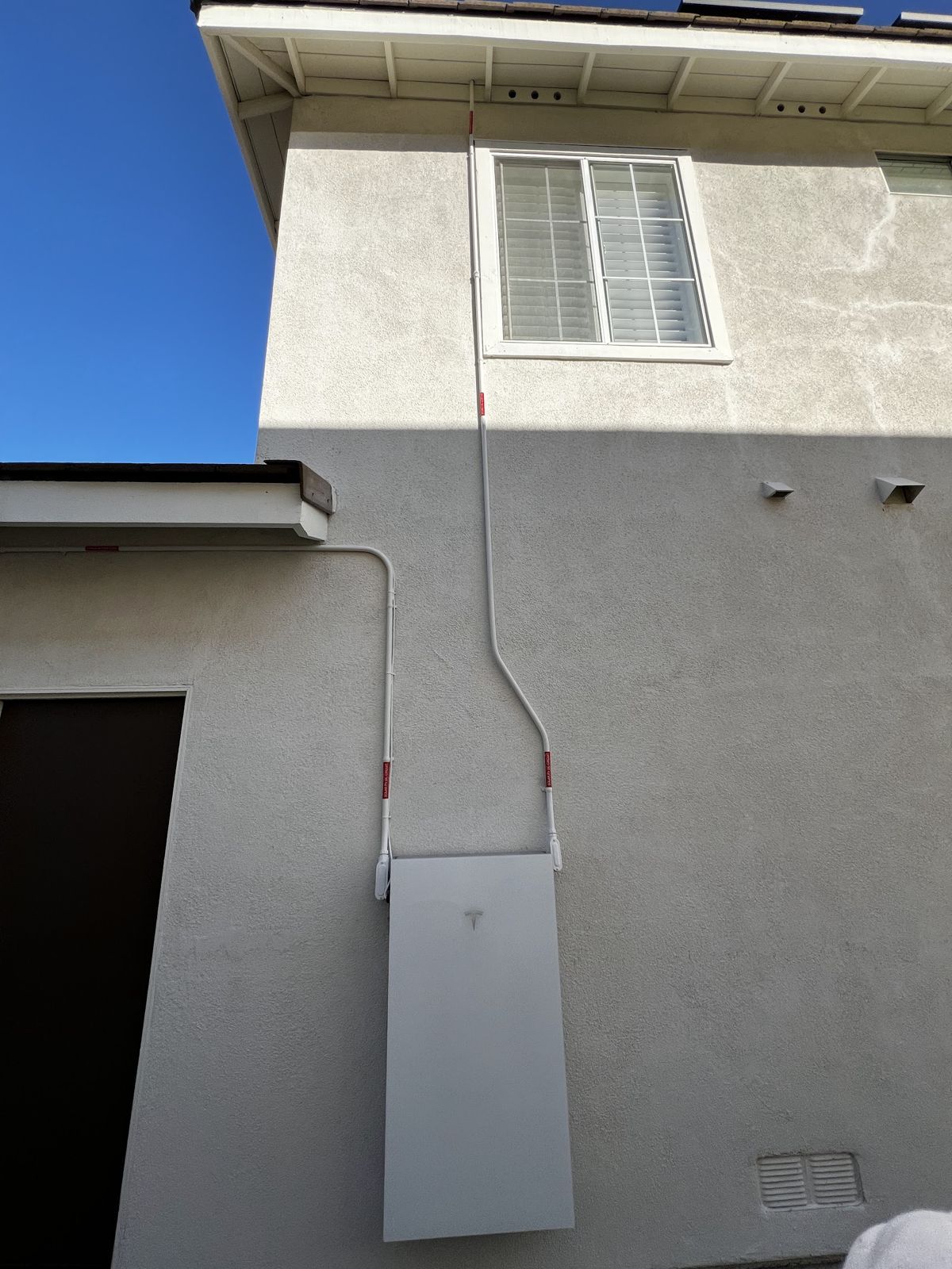 Tesla Powerwall mounted outside a home