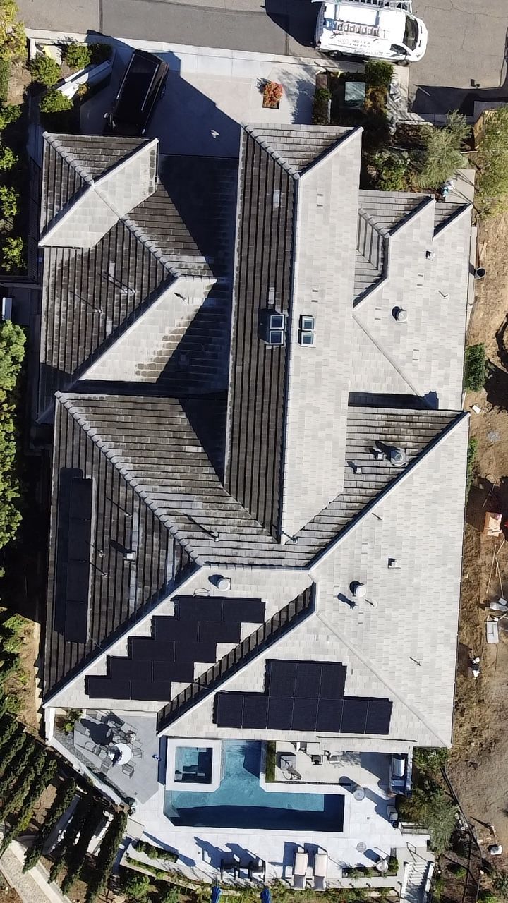Aerial view of a solar home with pool