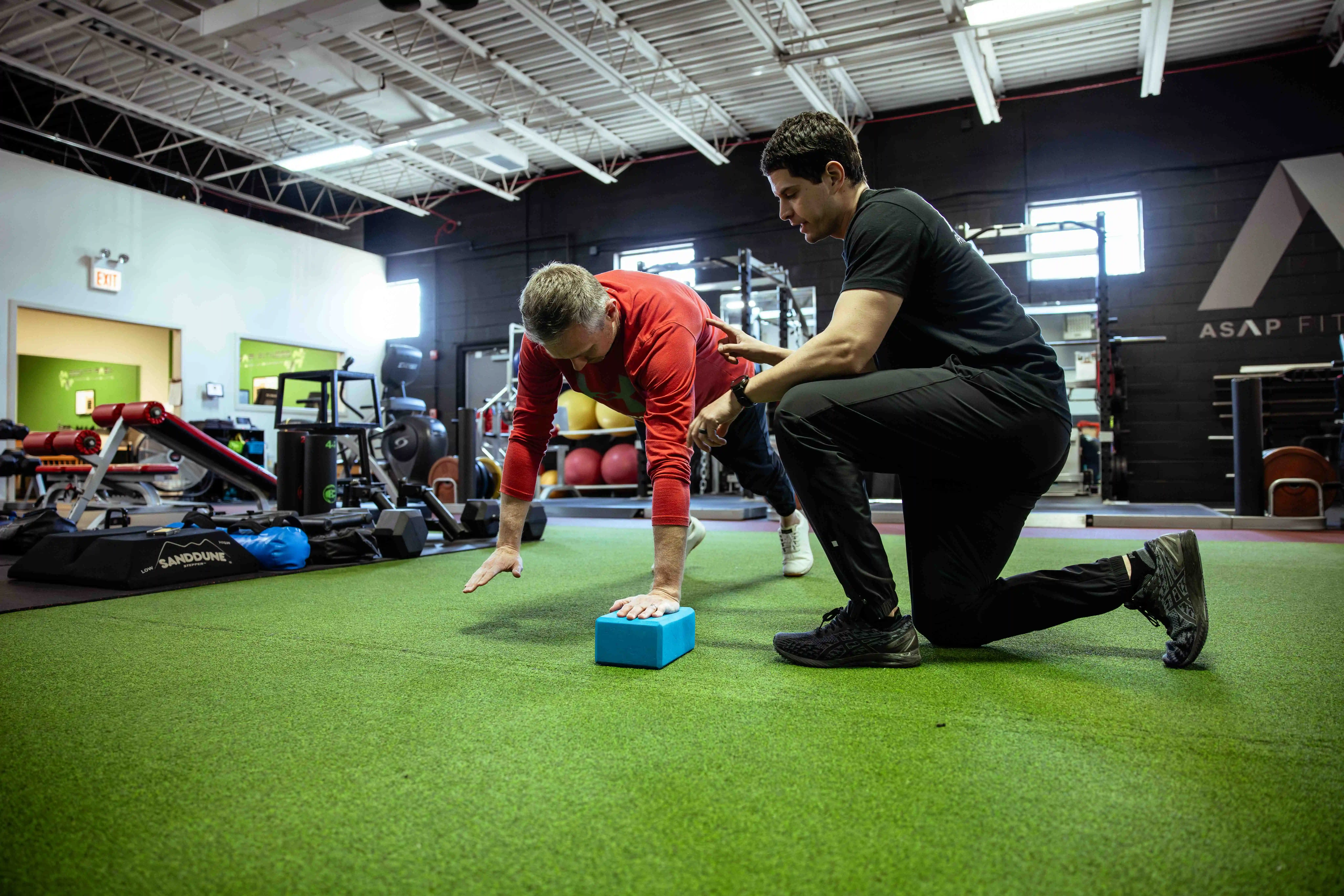 PT working with patient in gym