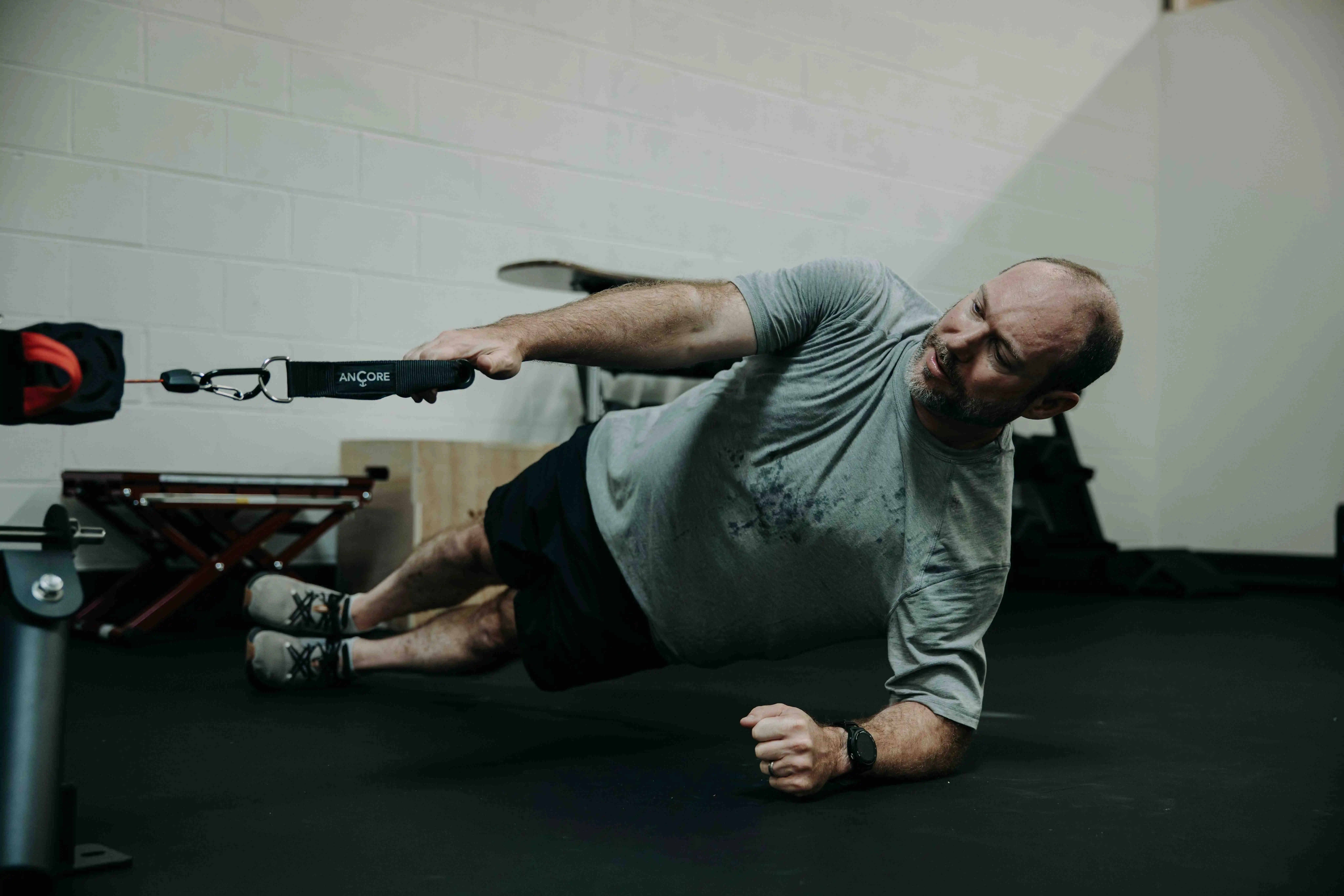 Athlete performing side plank with band