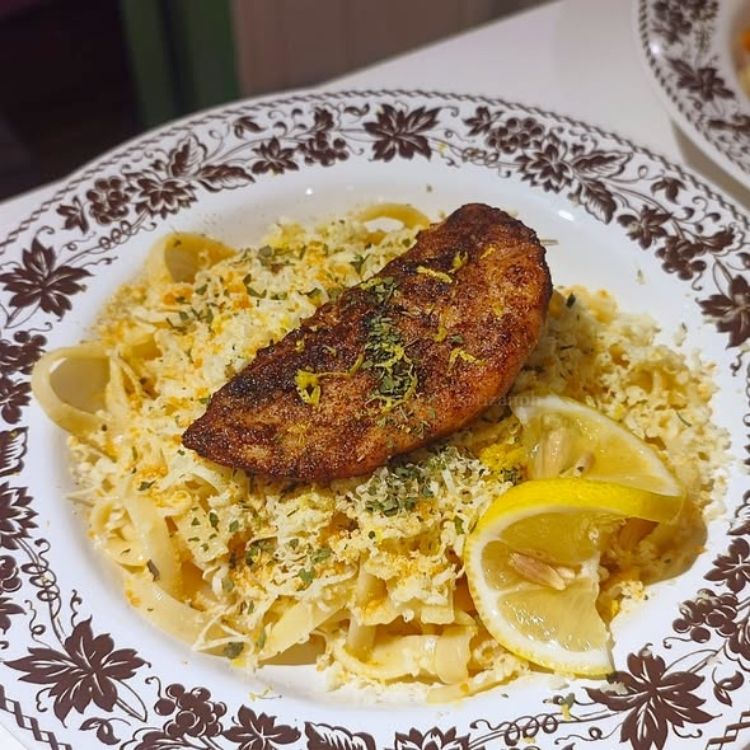 Creamy pasta served in a white bowl