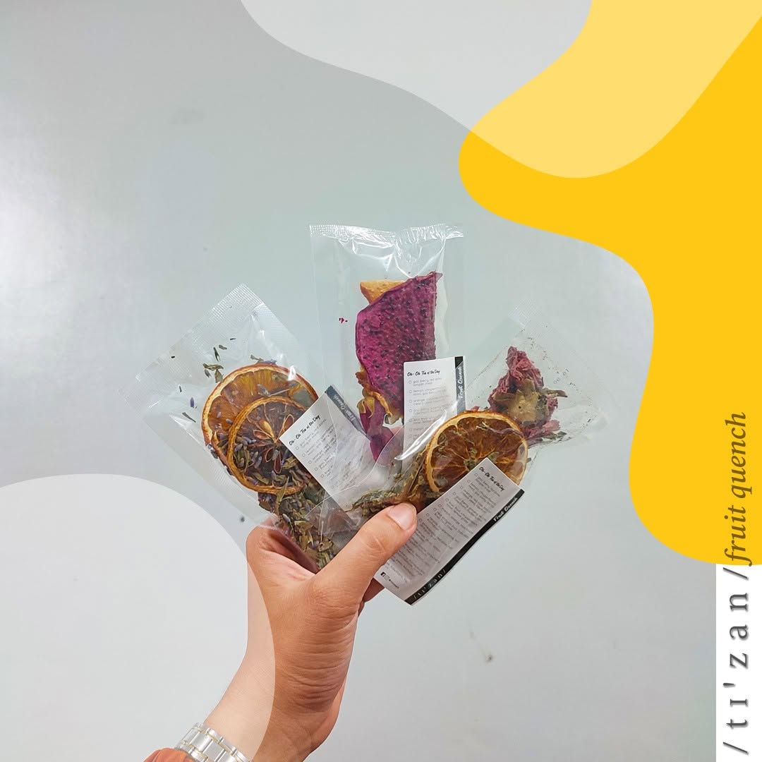 A hand holding Tizan fruit quench packs